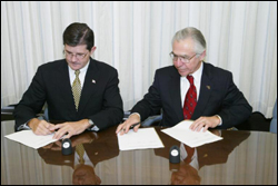 OSHA's then-Assistant Secretary, John Henshaw, and HPS' President, Kenneth Kase, sign national Alliance February 20, 2004.