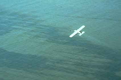 an airplane applying dispersant to an oil slick
