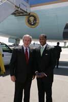 President George W. Bush presented the President’s Volunteer Service Award to Reggie Waller upon arrival at the airport in Philadelphia, Pennsylvania, on Wednesday, May 24, 2006.  Waller is a volunteer with Big Brothers Big Sisters Southeastern Pennsylvania and the United Way of Southeastern Pennsylvania. To thank them for making a difference in the lives of others, President Bush honors a local volunteer, called a USA Freedom Corps greeter, when he travels throughout the United States.  President Bush has met with more than 500 individuals around the country, like Waller, since March 2002.