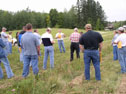 Don Hanson, Minnesota Department of Natural Resources, and David Lewis, A1 Cooperator of the Year, talk to the tour. Image by Debe Walchuk.