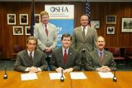 (Seated left to right) Bruce N. Scholnick, NWPCA, OSHA's then-Assistant Secretary, John Henshaw, and Dr. John Howard, NIOSH, sign the OSHA/NWPCA/NIOSH Alliance as Steve Geiges, NWPCA, Chairman of the Board-Elect and Pat Sherry, NWPCA, Chairman of the Board look on.
