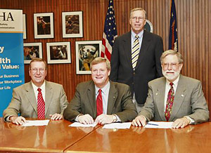 (Seated L-R) Larry Jones, President, BCSP, OSHA’s Assistant Secretary, Edwin G. Foulke, Jr., Adrian Hertog, President, CCHEST and standing Roger Brauer, Executive Director after renewing the national Alliance on July 12, 2006