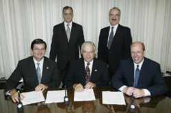 Front row, (L-R): OSHA's then-Assistant Secretary of Labor, John Henshaw; Ben Cook, President, NECA and John Grau, CEO and Executive Vice President, NECA sign national Alliance on August 12, 2003. Back row: Dave Potts, Director of Safety and Insurance, NECA and Emilio Roucco, Director of Public Relations, NECA.