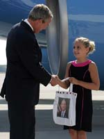 President George W. Bush met Alexandra Amend upon arrival in Cincinnati, Ohio, on Monday, August 16, 2004.  Amend, 10, raises money for charitable organizations by playing her violin in public places in Cincinnati. 
