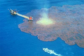 oil drilling platform in the open ocean surrounded by multicolored spilled oil.