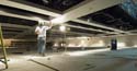 A worker applies plaster to the ceiling in the Congressional Auditorium