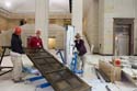 A crew raises one of the two bronze doors for the North Orientation Theater visitor entrance