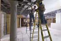 Workers secure drywall to the ceiling grid inside one of the CVC's two gift shops