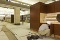 A carpenter installs cabinetry components in the Food Service Area