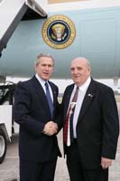 President George W. Bush presented the President’s Volunteer Service Award to Bob Woodard upon arrival in Pensacola, Florida, on Friday, March 18, 2005.  Woodard, 67, is an active volunteer with the Youth Motivator Mentor Program where he mentors 12 students in elementary and middle school, helping them with academics and providing encouragement and motivation.