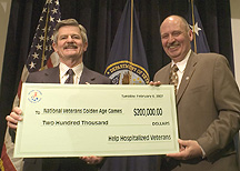 Secretary Nicholson (left) receives $200,000 check from HHV executive director Mike Lynch for Vets Golden Age Games.