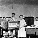 88091335-5 Teacher and Students in a Home Economics Room, n.d.