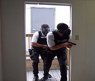 photo of men entering a room with guns drawn