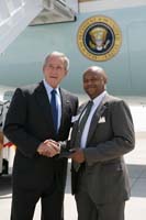 President George W. Bush presented the President’s Volunteer Service Award to Alex Robinson upon arrival in Wichita, Kansas, on Friday, June 15, 2007.  Robinson is a volunteer with the Boys & Girls Clubs of South Central Kansas.  To thank them for making a difference in the lives of others, President Bush honors a local volunteer when he travels throughout the United States.  President Bush has met with more than 575 individuals like Robinson since March 2002.