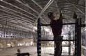 A worker secures metal studs in place for the Great Hall vaulted ceiling