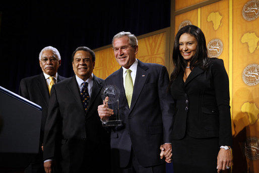 President George W. Bush is presented with an award by Ambassador Andy Young, Chairman of the Board, The Leon H. Sullivan Foundation, for his dedication and committed service to Africa, after speaking to The Leon H. Sullivan Foundation Tuesday, Feb. 26, 2008, in Washington, D.C. Joining them on stage is Ambassador Howard Jeter, president and CEO of The Leon H. Sullivan Foundation, far left, and Hope Masters, daughter of the late Rev. Leon H. Sullivan. White House photo by Eric Draper