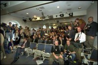 Image of a press room and reporters