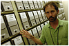 Christopher McDermott, a historian for the Central Identification Lab, shows the filing system for cases under investigation at the JPAC. Historians piece together information from databases, tips that come in from around the world and information in case files to determine first if the site is likely to yield the remains of missing servicemembers. Defense Dept. photo by Fred W. Baker III