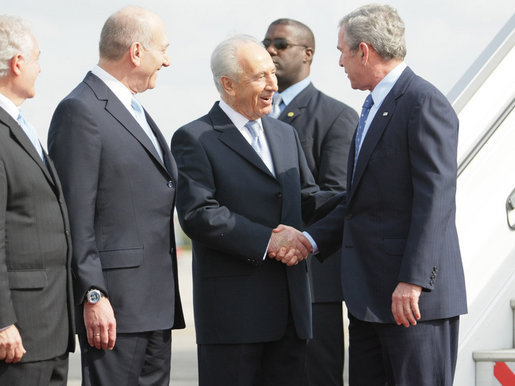 President George W. Bush is greeted by Israel’s President Shimon Peres, center, and Prime Minister Ehud Olmert after arriving in Tel Aviv Wednesday, Jan. 9, 2008, for a weeklong visit to the Mideast. White House photo by Eric Draper