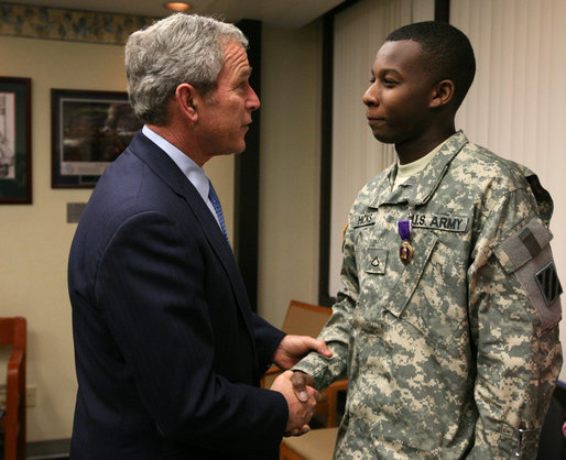 President George W. Bush shakes the hand of U.S. Army PFC Demario Hicks of Fort Stewart, Ga., Thursday, Dec. 20, 2007, after presenting him with a Purple Heart during his visit to Walter Reed Army Medical Center in Washington, D.C., where the soldier is recovering from injuries suffered in Operation Iraqi Freedom. White House photo by Joyce N. Boghosian