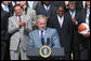 President George W. Bush acknowledges the applause as he greets the University of Kansas Jayhawks Tuesday, June 3, 2008, to the Rose Garden. President Bush told the 2008 NCAA Men's Basketball champs, "I want to congratulate this team. You brought new glory to one of our nation's most storied basketball programs, and you gave your fans all across America one more reason to chant: Rock Chalk, Jayhawk!" White House photo by Joyce N. Boghosian