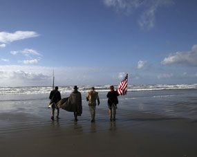 Lewis and Clark reenactors approach the Pacific Ocean.