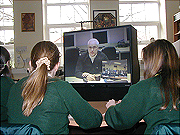 NASA engineer and students communicate via videoconference system.