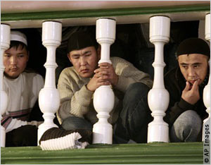 Muslim men at prayer service (AP Images)