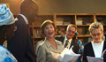 Laura Bush and Senegal’s first lady Viviane Wade examine school books