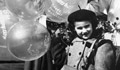 A girl holding balloons