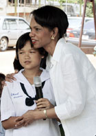 Secretary Rice hugs a Thai school girl after she led a group singing for her at Bang Sak school which was devastated by the last December's tsunami and was rebuilt as part of the U.S. reconstruction efforts in Pang-nga province, southern Thailand.