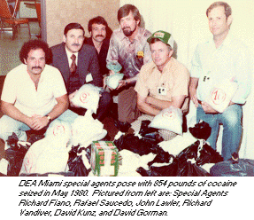 photo - DEA Miami special agents pose with 854 pounds of cocaine seized in May 1980.
