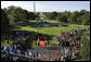 President George W. Bush and President John Agyekum Kufuor of Ghana, seen from the Truman Balcony of the White House, stand together during the South Lawn Arrival Ceremony of President John Agyekum Kufuor and Mrs. Theresa Kufuor of Ghana at the White House. White House photo by Grant Miller