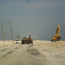 Heavy equipment moves sand off J. Earle Bowden Way.