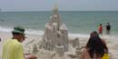 Visitors observe a sand castle on Perdido Key Beach in Florida.