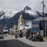 View of historic district of Skagway showing Victorian style buildings against a spectacular mountain and glacier backdrop