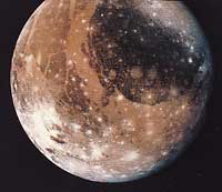 Ganymede, a moon of Jupiter, has craters and cracks on its surface. Asteroids and comets that hit Ganymede made the craters. The cracks are due to expansion and contraction of the surface.
