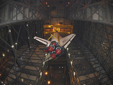 Space shuttle Endeavour is lifted inside the Vehicle Assembly Building.