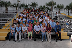 Harmony naming group poses in front of the Saturn V center