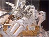 Astronauts working on Hubble in space