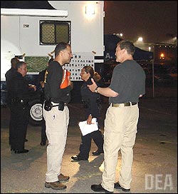 (L-R:) DEA Los Angeles Associate SAC/HIDTA Director Briane Grey and U.S. Attorney Tom O'Brien speak at 3:30 a.m. PST at the unified command post prior to the operation.