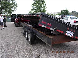 A pickup truck towing a goose neck trailer (left)