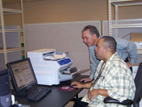 Data conversion personnel looking at a scanned OPF document.