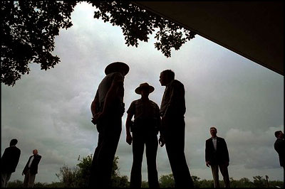 President George W. Bush talks with national park service officers at the Royal Palm Visitors Center at Everglades National Park, Fla., June 4, 2001. White House photo by Eric Draper.