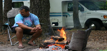 a picture of a camper enjoying a campfire