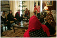 Laura Bush and Dr. Zenat Karzai, wife of President Hamid Karzai, U. S. Secretary of Education Margaret Spellings, second left, and Under Secretary of State for Global Affairs Paul Dobrianski, left, talk with Afghan women about issues of women's rights and education at the presidential residence in Kabul, Afghanistan Wednesday, March 30, 2005. 