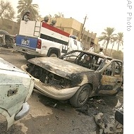 Iraqi police drives past damage made by two car bombs in central commercial district of Karrada in Baghdad, 15 Sep 2008