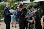President George W. Bush talks with women who are members of Women and Children of Hope and the Nigerian Community of Western Living with AIDS at National Hospital in Abuja, Nigeria on July 12, 2003.