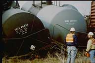 Two derailed tank cars lie close together.