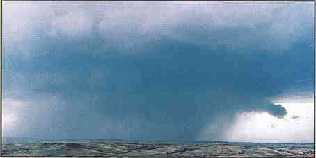 Tornado obsured by rain and clouds